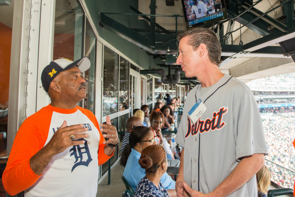 United Way for Southeastern Michigan President and CEO Herman Gray speaks with Scott Linnell, who won an auction for the right to throw out the first pitch at Comerica Park, with proceeds going to United Way.
