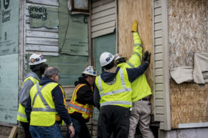Access for All teachers and students help board up a vacant home in southwest Detroit as part of a weeklong work project.