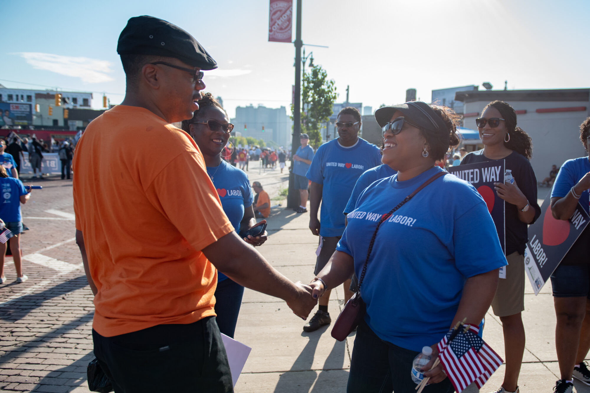 United Way for Southeastern Michigan's CEO shakes hands at the Labor Day March.