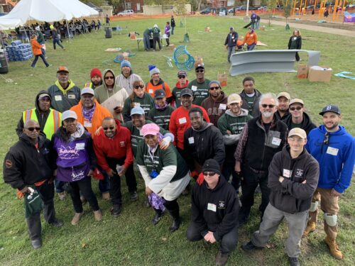 United Way and Labor partners pause to pose for a group photo while building a playground.