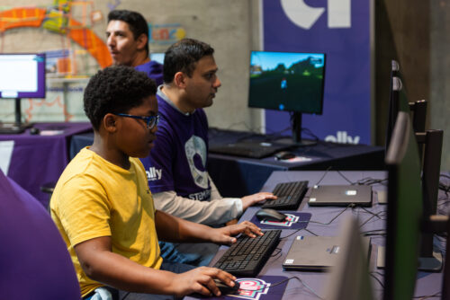 Student plays coding games on computers.