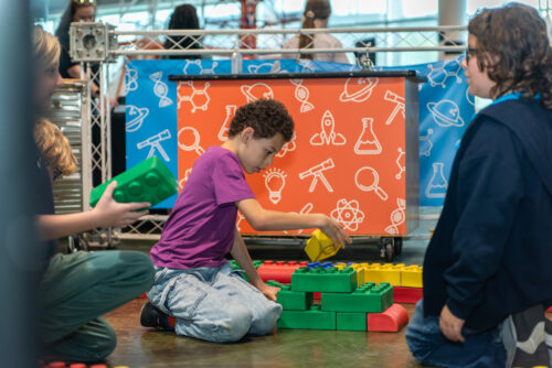 Student plays with giant legos.