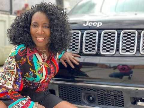  Dorothy Leverette poses in front of a Jeep