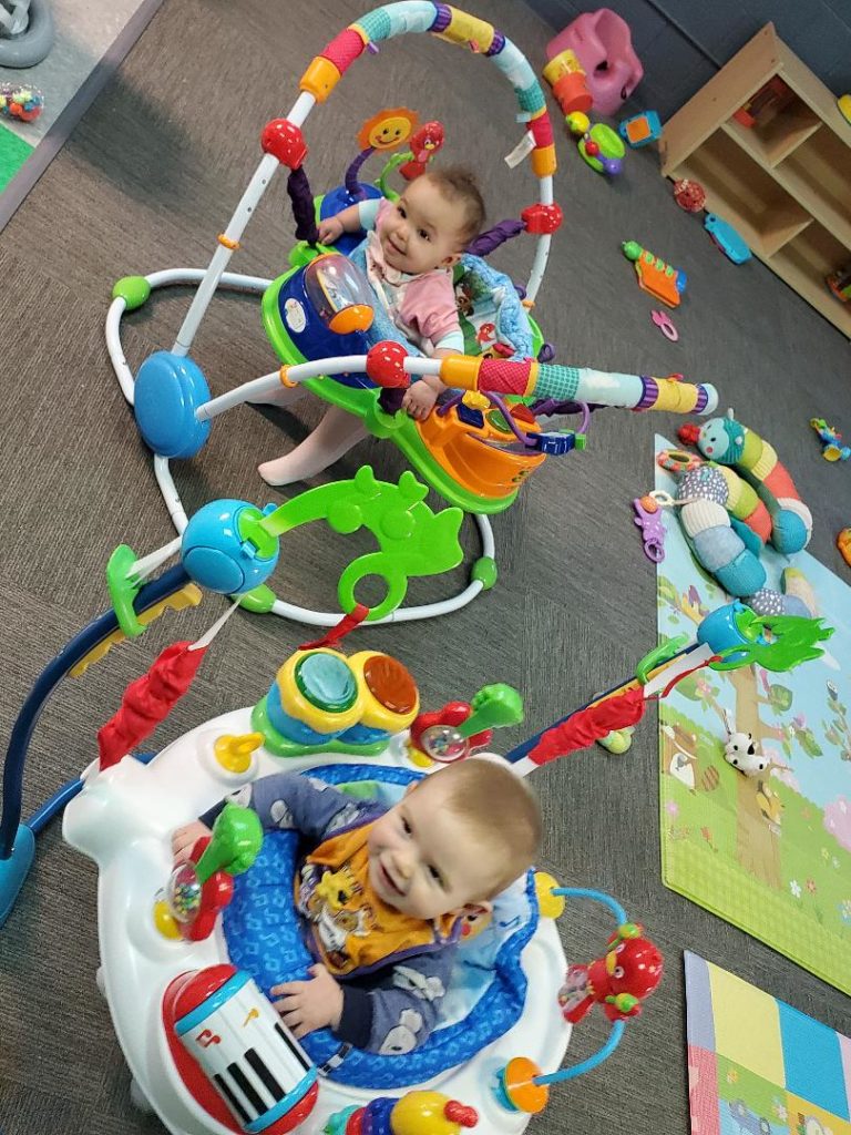 Babies play while six feet apart.